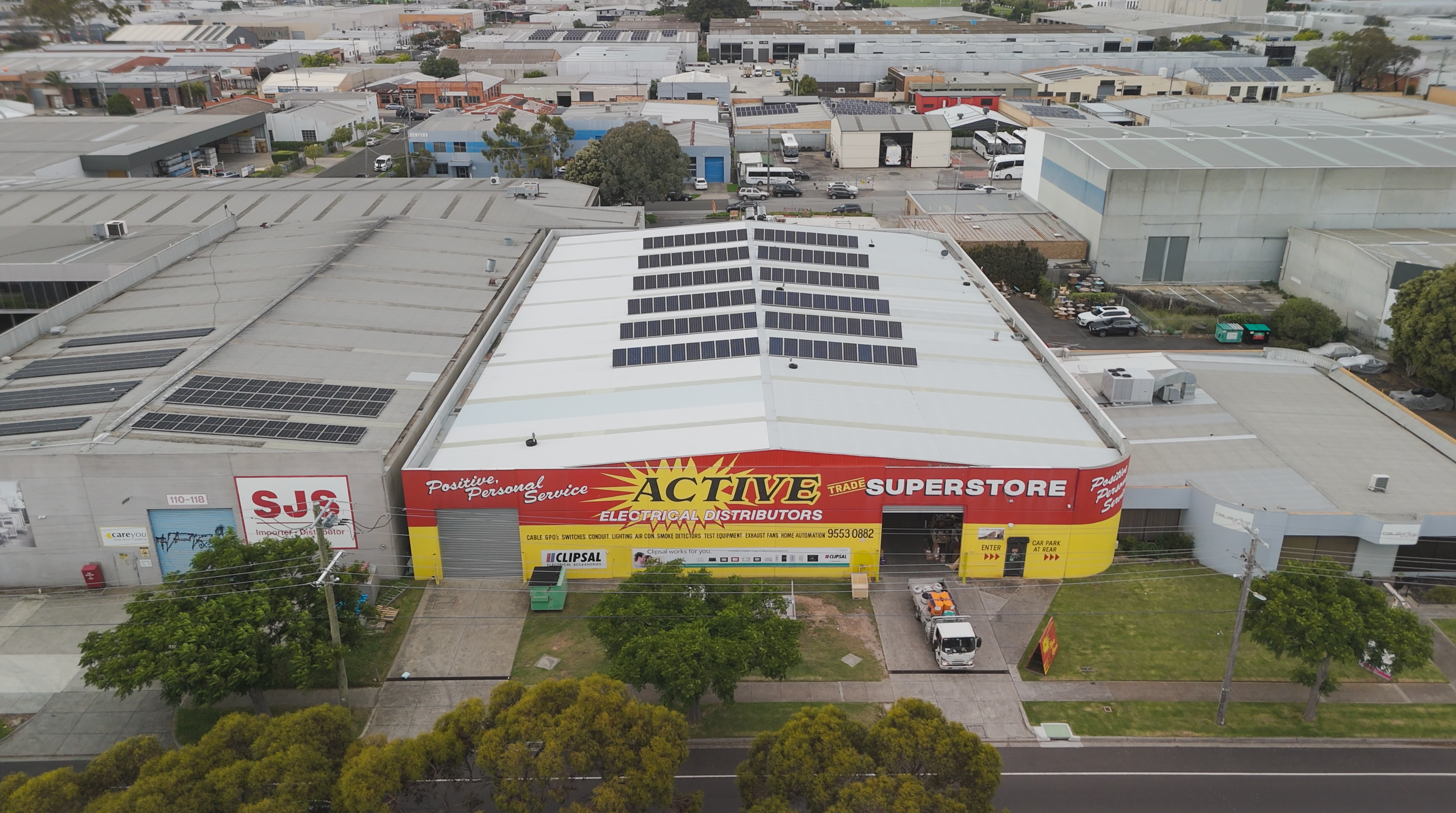 A worker wearing security gear looking at a power line